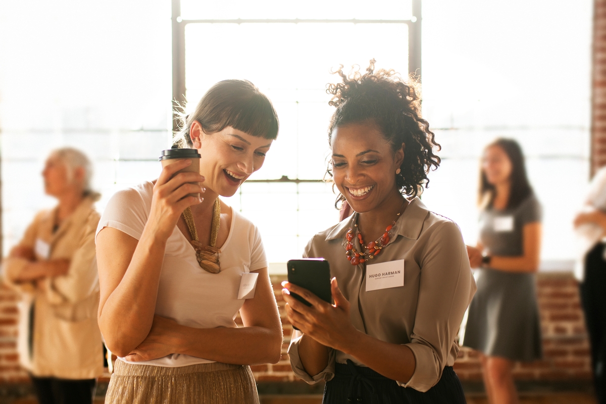 Two women talking at a networking event